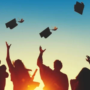 A group of people throwing their caps in the air.