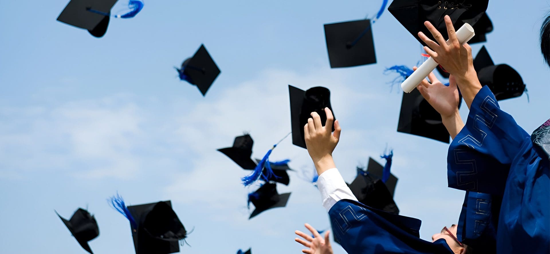 A person in the air with many hats flying