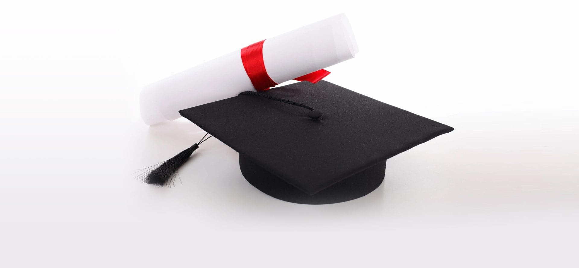 A graduation cap and diploma on top of the table.