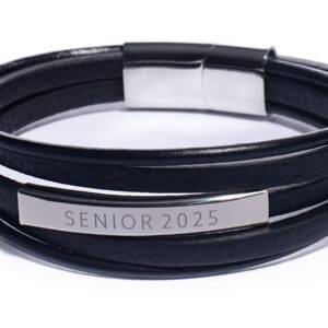 A black leather bracelet with silver lettering.